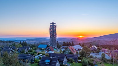 Drohnenansicht vom hölzernen Turm mit Erlebnisrutsche und Blick auf die umliegenden Gebäude